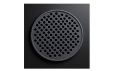 Black perforated round object on a dark background