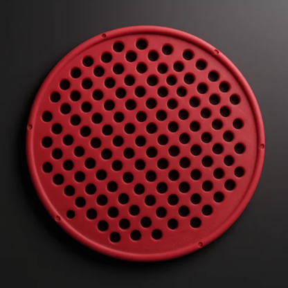 Red circular object with holes on a black background