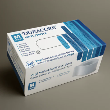 Box of Duracore vinyl medical examination gloves on a gray background