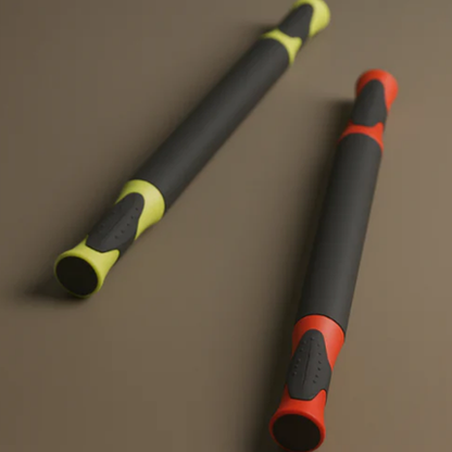 Two cylindrical objects with colorful handles on a brown background
