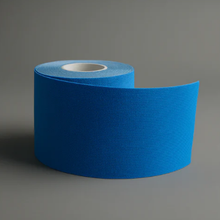 Roll of blue tape on a gray background