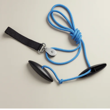 Black leather strap with blue cord on a beige background